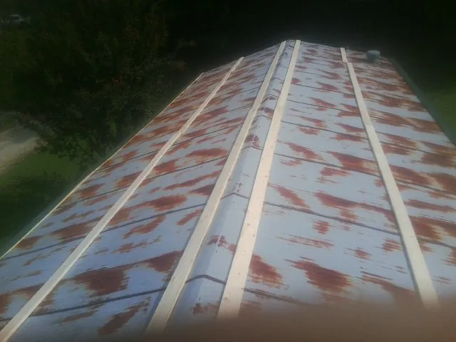 Rusted metal roof panels with new wood purlins before replacement — Storm Damage Roof Repair in Bordentown by Roofing Brothers